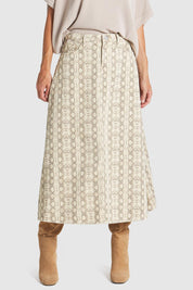 A model wearing the Chameleon Denim Skirt in colour Snakeskin, from the front, cropped image