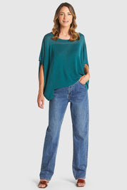 A model wearing the Irises Knit Top in colour Teal (Green), from the front, showing the whole outfit