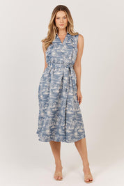 A model wearing the Zanzabar Dress in colour Bluereed (Blue), from the front, showing the whole outfit
