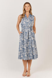 A model wearing the Zanzabar Dress in colour Bluereed (Blue), from the front, showing the whole outfit