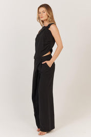 A model wearing the Sandara Pant in colour Black (Black), from the front, showing the whole outfit