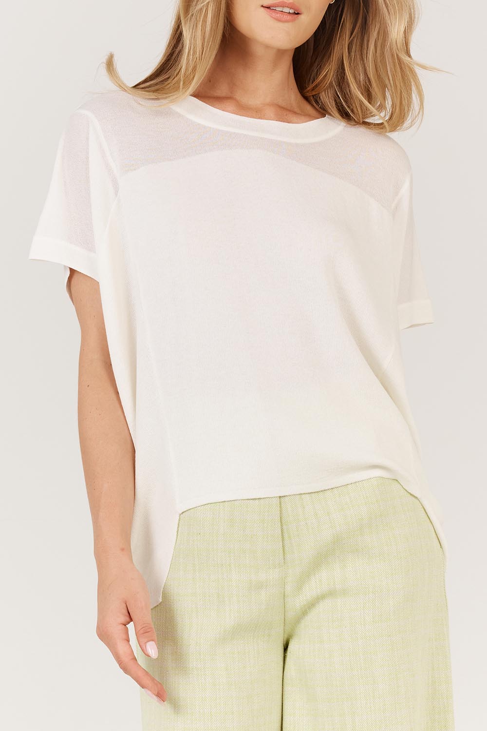 A model wearing the Corsica Knit Top in colour White (White), from the front, cropped image