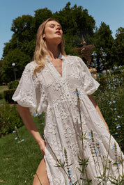 A model wearing the Gardenia Cotton Dress in colour White (White), from the front, showing the whole outfit