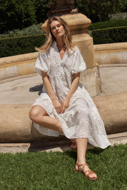 A model wearing the Gardenia Cotton Dress in colour White (White), from the front, showing the whole outfit