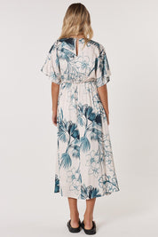 A model wearing the Solstice Palms Midi Dress in colour Palm (Blue), from the back