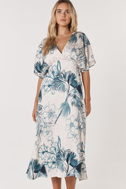 A model wearing the Solstice Palms Midi Dress in colour Palm (Blue), from the front, cropped image