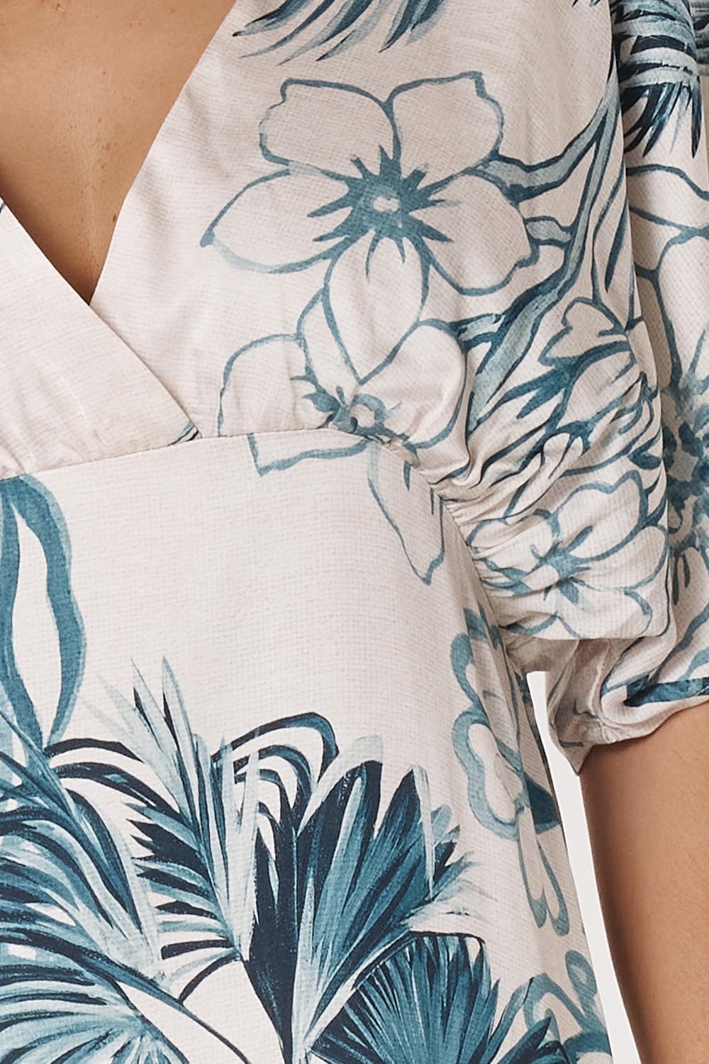 A model wearing the Solstice Palms Midi Dress in colour Palm (Blue), from the front, cropped image