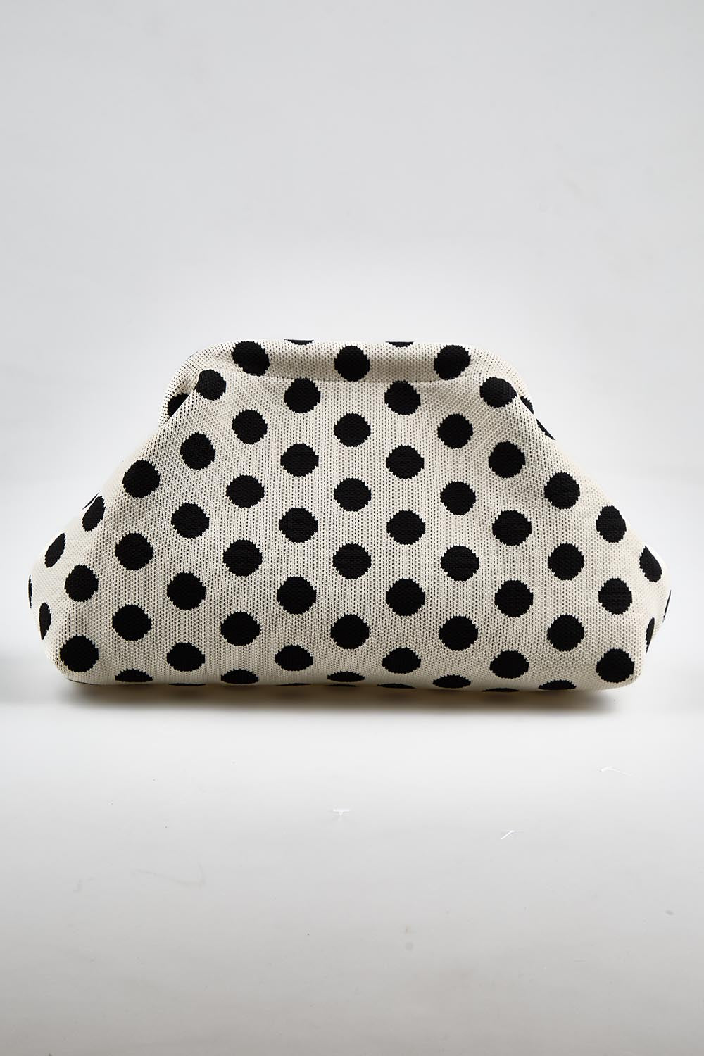 Model Genericm wearing size sample of the Bondi Spot Clutch - Whiteblack in colour Whiteblack, from the front