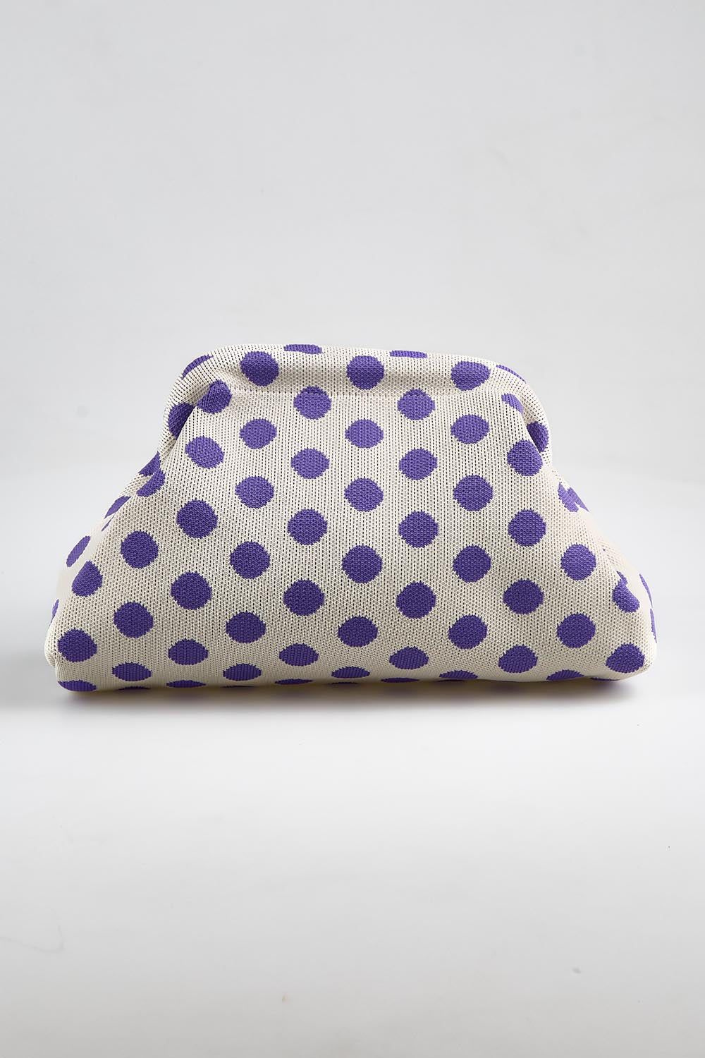 Model Genericm wearing size sample of the Bondi Spot Clutch - Whitepurple in colour Whitepurple, from an angle