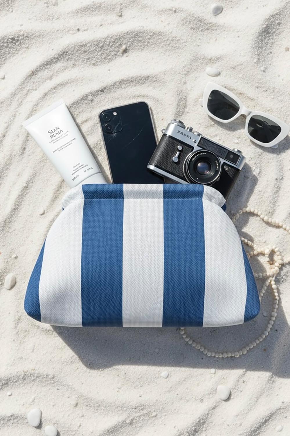 Product shot of the Laguna Stripe Clutch - Bluewhite in colour Bluewhite, from the front