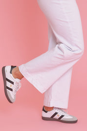 Model Ziara wearing size 39 of the 2001 Parallel Suede Sneaker in colour Whiteblack (White), from the front, showing the whole outfit