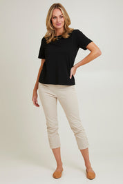 Model Grace wearing size 10 of the Cotton Twill Pant in colour Natural, from the front, showing the whole outfit