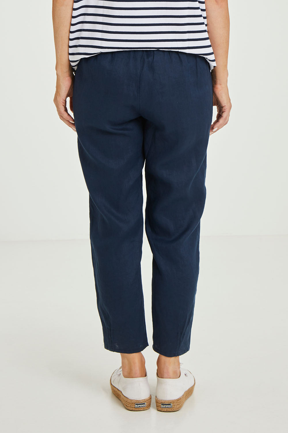 Model Luisa wearing size 10 of the Jersey Waist Linen Pant in colour Marine (Blue), from the back