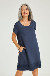 Model Luisa wearing size 10 of the Frilled Hem Linen Dress in colour Marine (Blue), from the front, cropped image