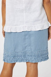 Model Cara wearing size 10 of the Frill Hem Pull On Linen Skirt in colour Powder (Blue), from the back