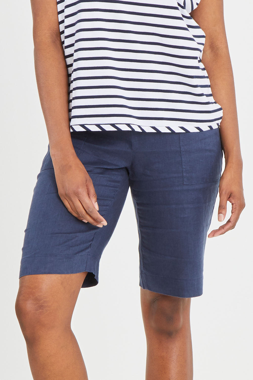 Model Aiyana wearing size 10 of the Pull On Linen Short in colour Marine (Blue), from the front, cropped image