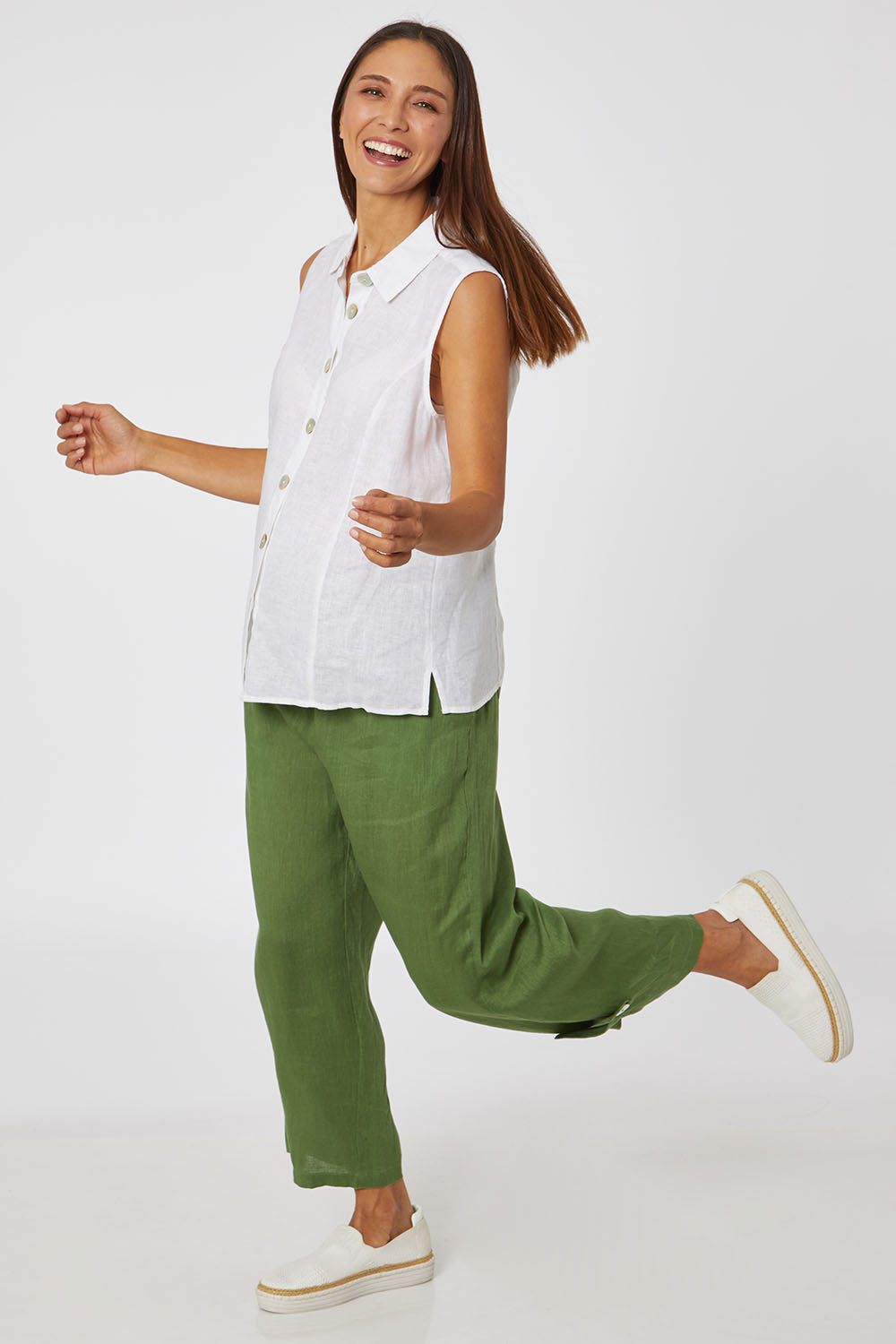 Model Cara wearing size 10 of the Side Button Pant in colour Green (Green), from the front, showing the whole outfit