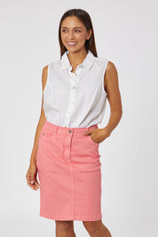Model Cara wearing size 10 of the Miracle Denim Skirt in colour Coral (Pink), from the front, cropped image