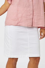 Model Cara wearing size 10 of the Miracle Denim Skirt in colour White (White), from the front, cropped image