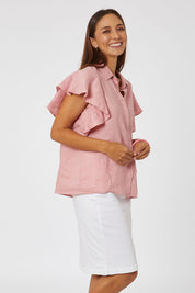 Model Cara wearing size 10 of the Miracle Denim Skirt in colour White (White), from the front, cropped image