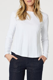 A model wearing the Crew Neck Long Sleeve Cotton Top in colour White (White), from the front, cropped image