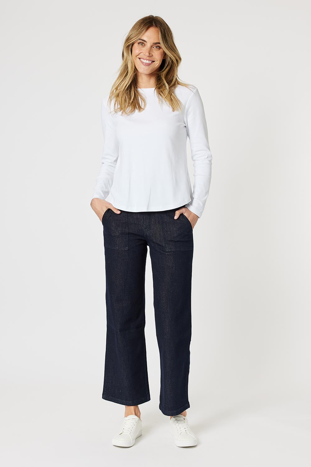 A model wearing the Crew Neck Long Sleeve Cotton Top in colour White (White), from the front, showing the whole outfit
