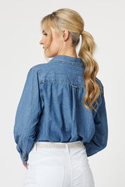 A model wearing the Denim Shirt in colour Denim (Blue), from the back
