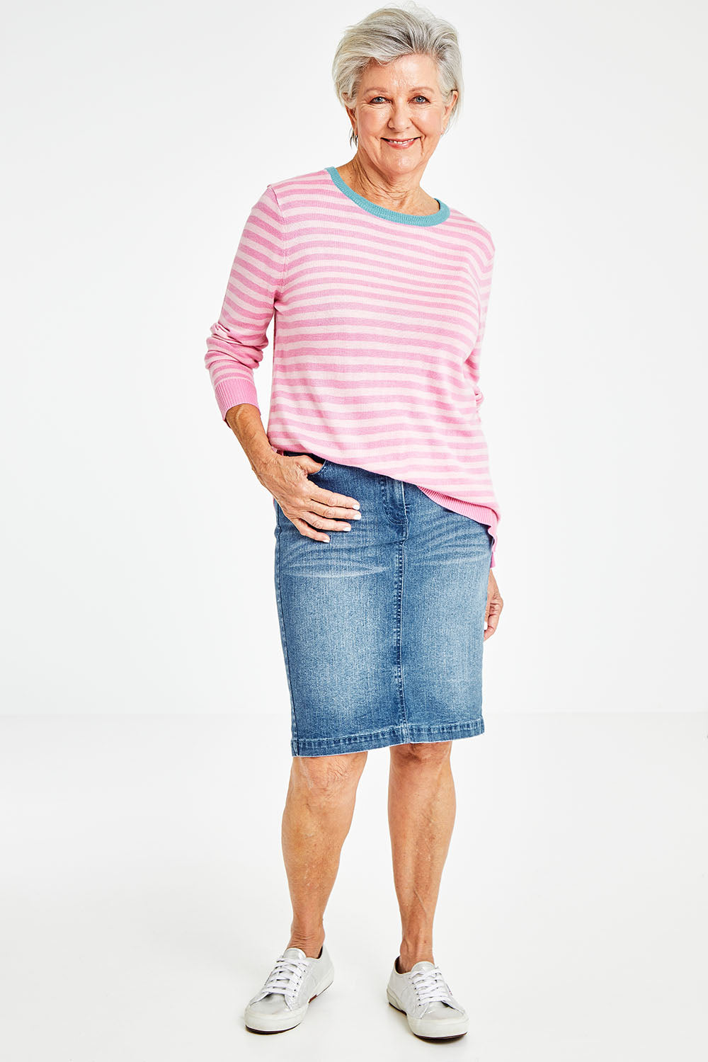 Model Elise wearing size 10 of the Miracle Denim Straight Skirt in colour Denim (Blue), from the front, showing the whole outfit