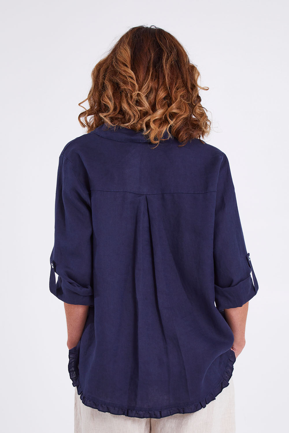 Model Emma wearing size 10 of the Ruffle Hem Linen Shirt in colour Navy (Blue), from the back