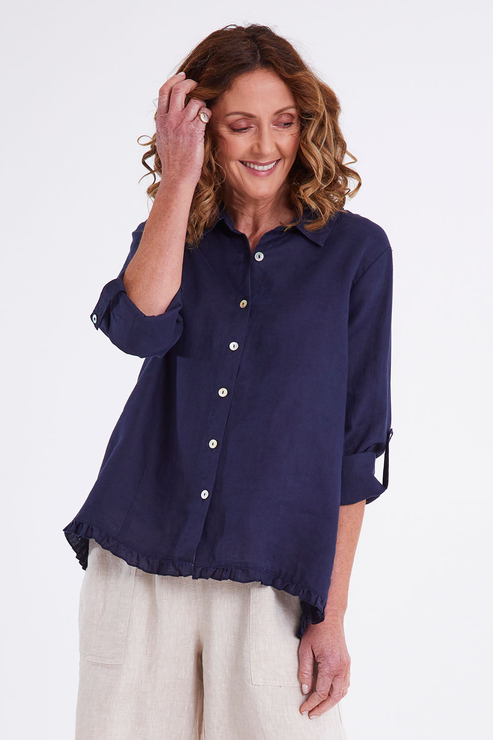 Model Emma wearing size 10 of the Ruffle Hem Linen Shirt in colour Navy (Blue), from the front, cropped image