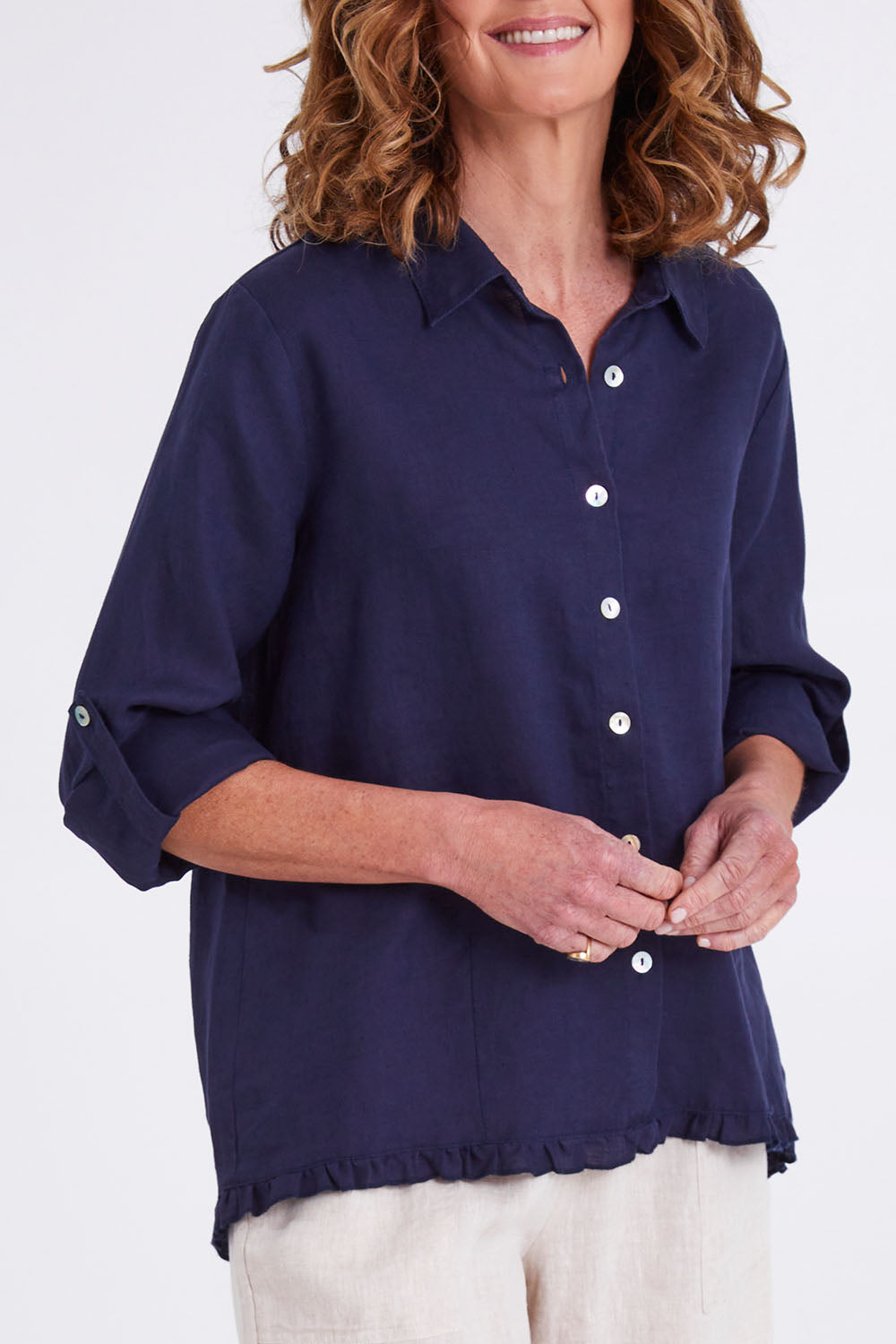 Model Emma wearing size 10 of the Ruffle Hem Linen Shirt in colour Navy (Blue), from the front, cropped image