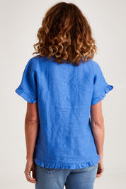 Model Emma wearing size 10 of the Alex Ruffle Linen Top in colour Cobalt (Blue), from the back