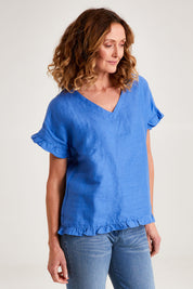 Model Emma wearing size 10 of the Alex Ruffle Linen Top in colour Cobalt (Blue), from the front, cropped image