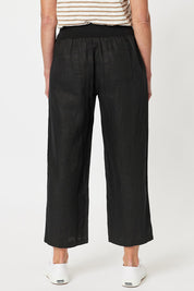 A model wearing the Classic Wide Leg Linen Pant in colour Black (Black), from the back