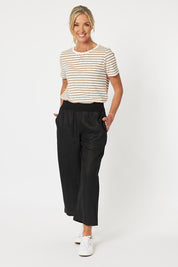 A model wearing the Classic Wide Leg Linen Pant in colour Black (Black), from the front, showing the whole outfit