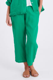 Model Emma wearing size 10 of the Classic Wide Leg Linen Pant in colour Emerald (Green), from the front, cropped image
