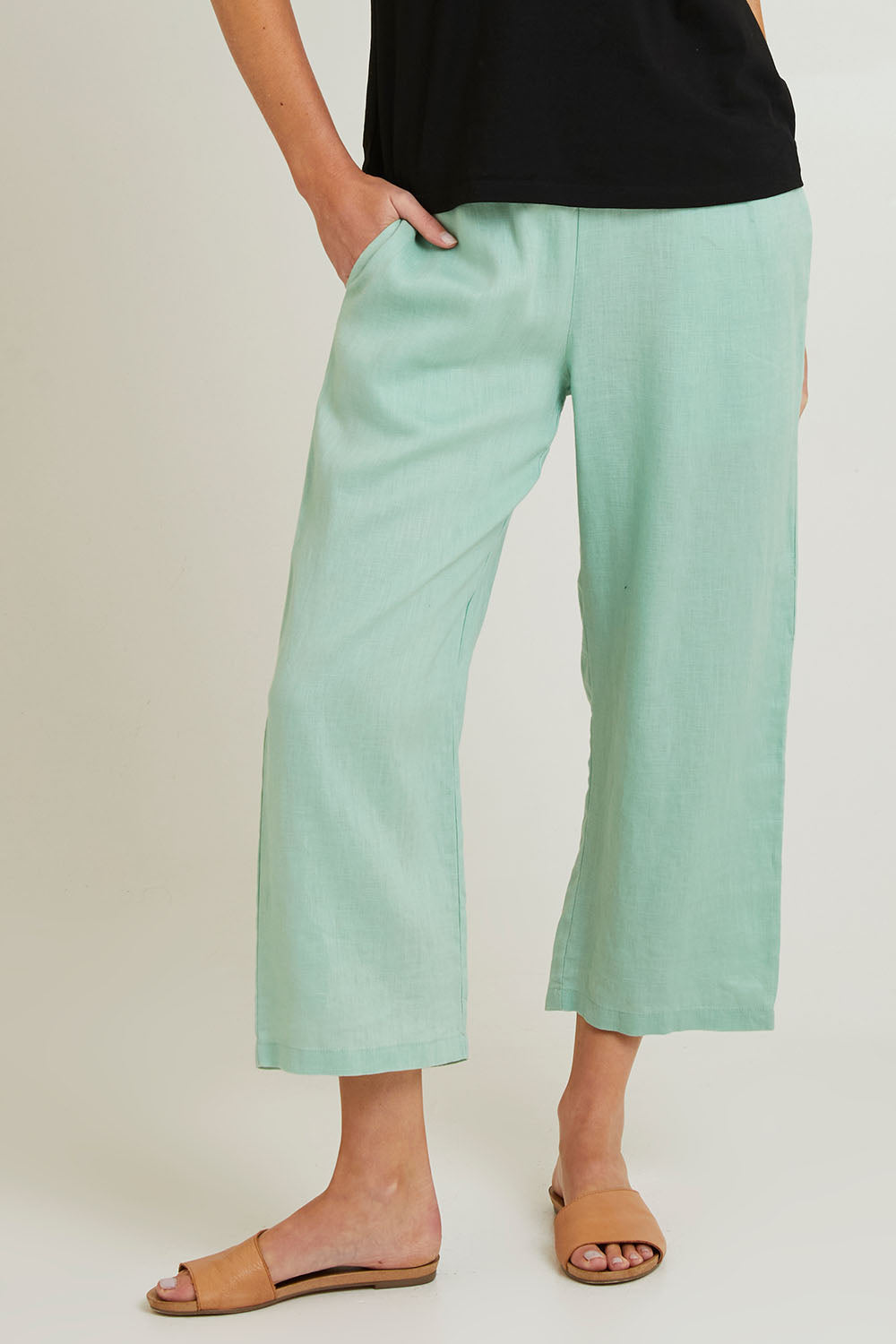 Model Grace wearing size 10 of the Classic Wide Leg Linen Pant in colour Mint (Green), from the front, cropped image