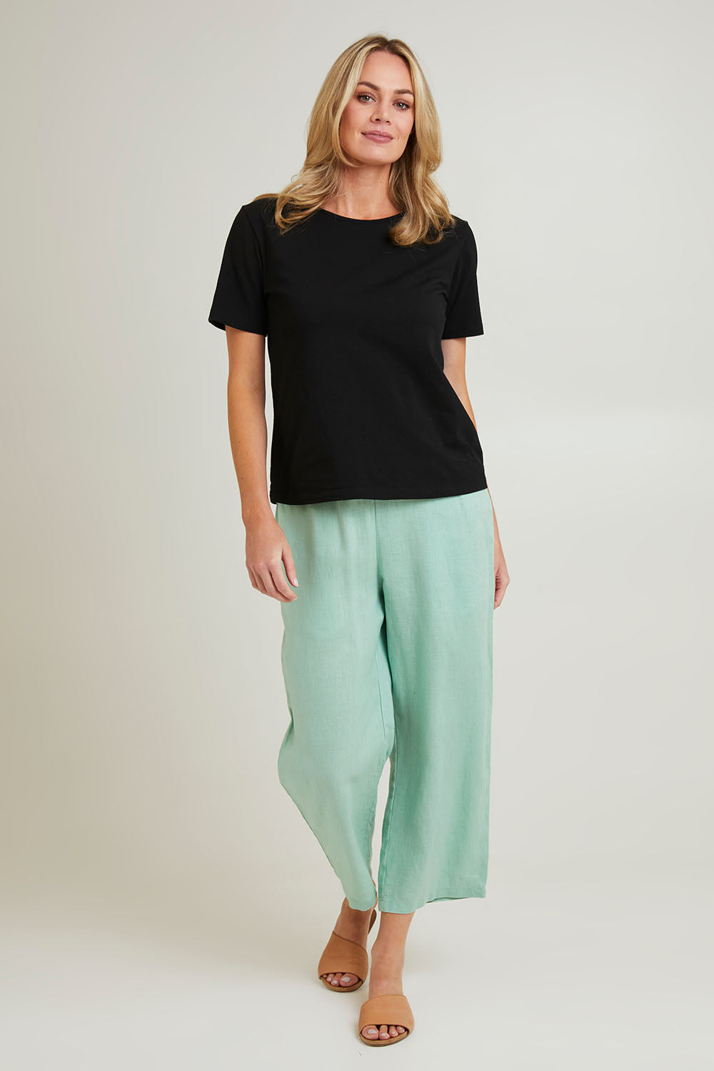 Model Grace wearing size 10 of the Classic Wide Leg Linen Pant in colour Mint (Green), from the front, showing the whole outfit