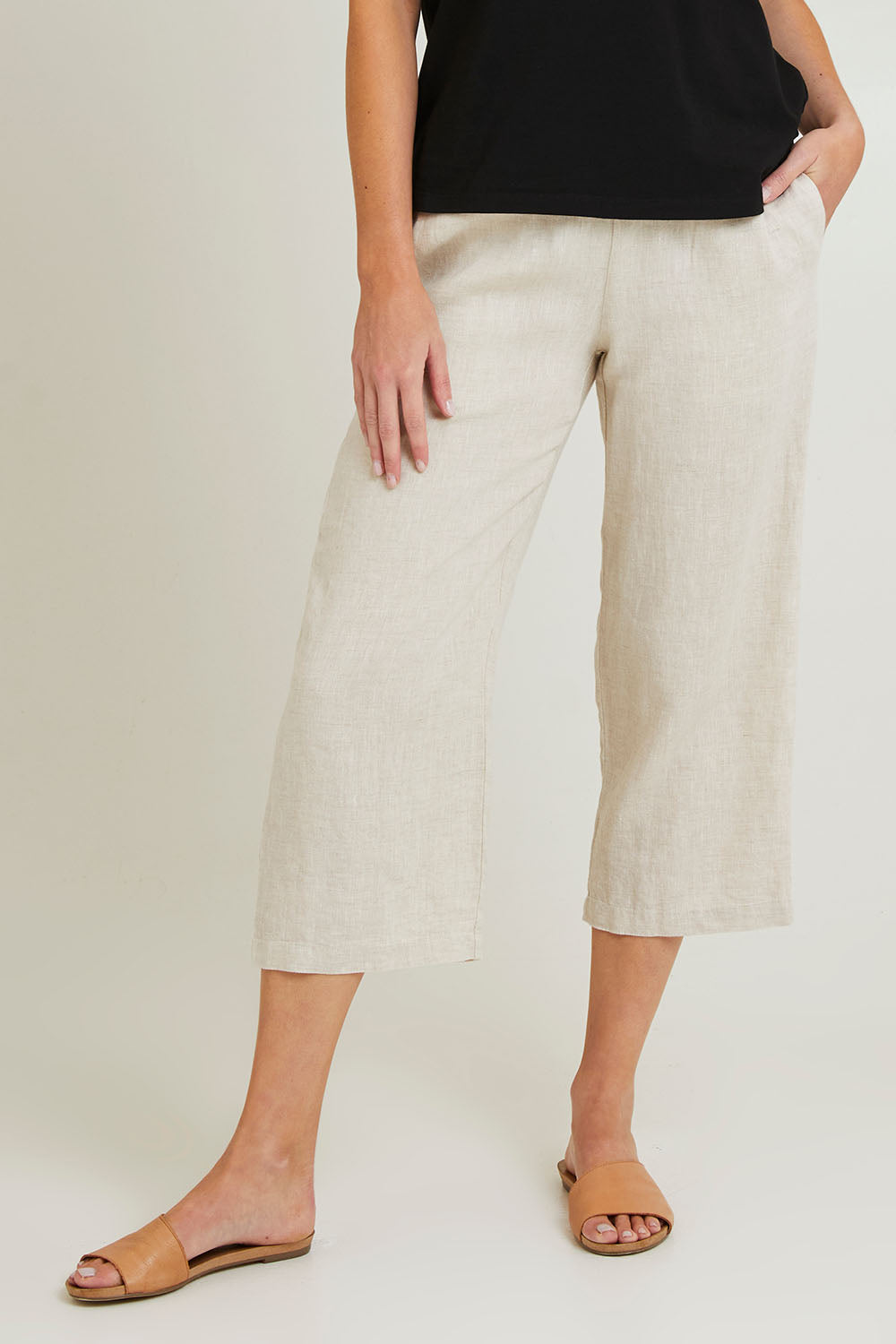 Model Grace wearing size 10 of the Classic Wide Leg Linen Pant in colour Natural, from the front, cropped image