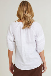 Model Grace wearing size 10 of the Diana Linen Top in colour White (White), from the back