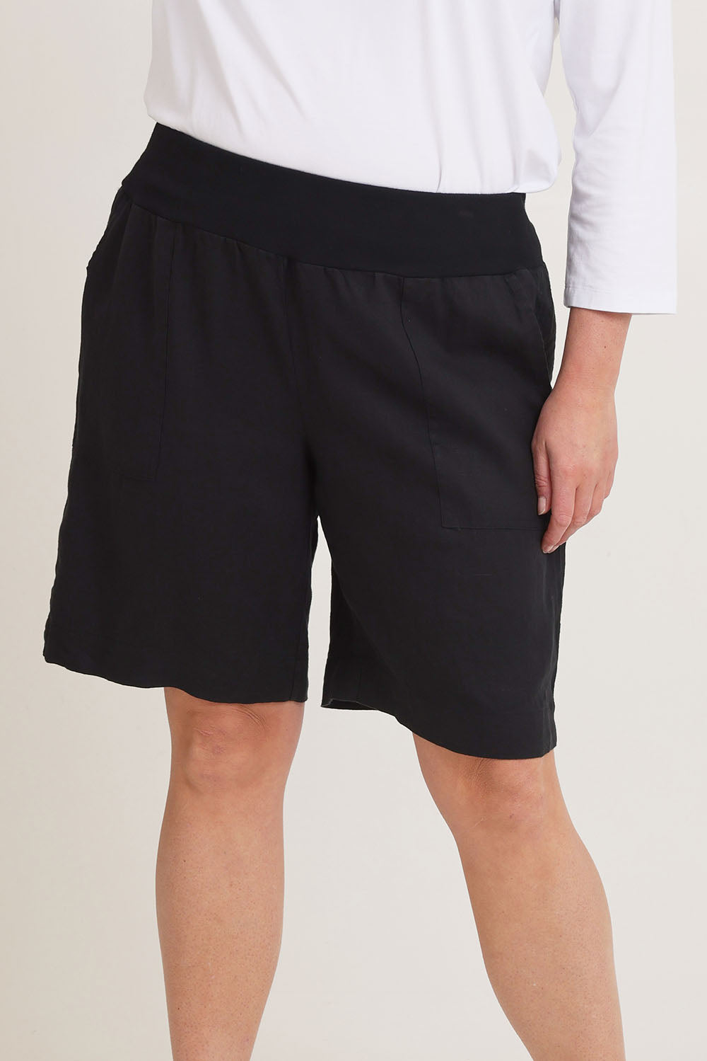 Model Chanel wearing size 16 of the Jersey Waist Linen Short in colour Black (Black), from the front, cropped image