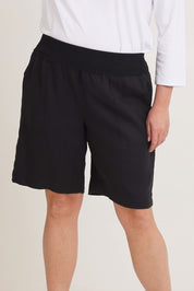 Model Chanel wearing size 16 of the Jersey Waist Linen Short in colour Black (Black), from the front, cropped image