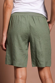 Model Madeline wearing size 10 of the Jersey Waist Linen Short in colour Khaki (Green), from the back