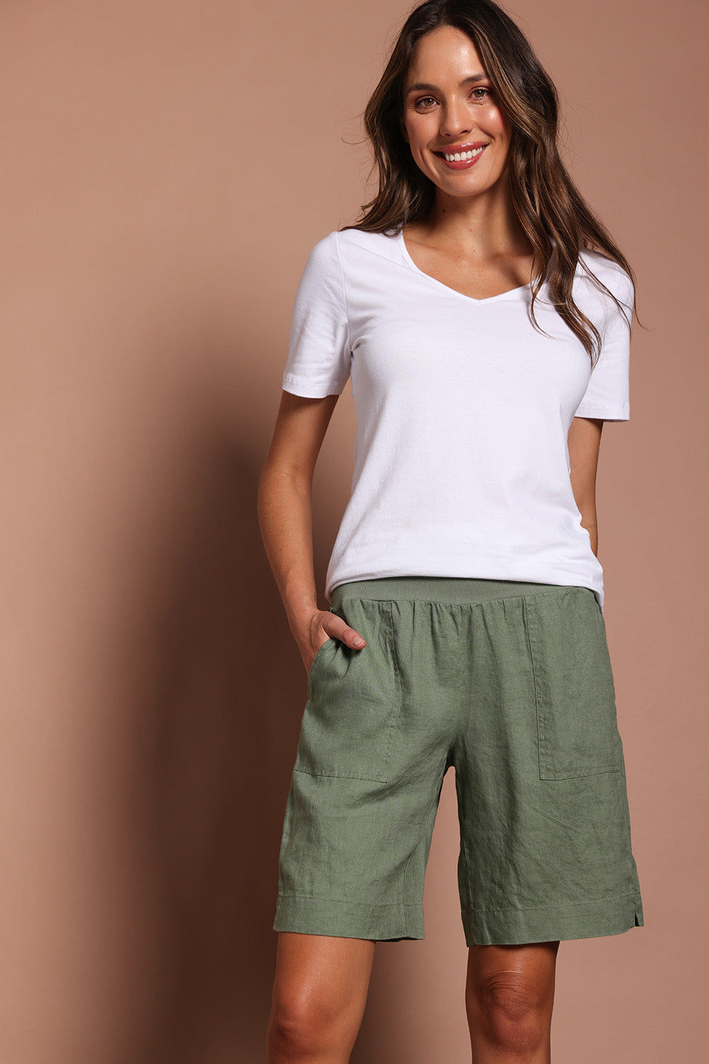 Model Madeline wearing size 10 of the Jersey Waist Linen Short in colour Khaki (Green), from the front, cropped image