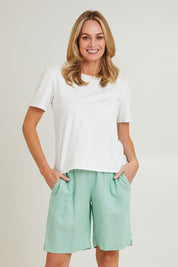 Model Grace wearing size 10 of the Jersey Waist Linen Short in colour Mint, from the front, cropped image