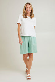 Model Grace wearing size 10 of the Jersey Waist Linen Short in colour Mint, from the front, showing the whole outfit