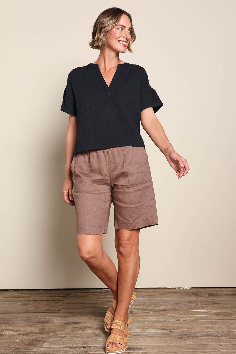 Model Riinar wearing size 10 of the Jersey Waist Linen Short - Mocha in colour Mocha, from the front