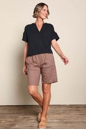 Model Riinar wearing size 10 of the Jersey Waist Linen Short - Mocha in colour Mocha, from the front