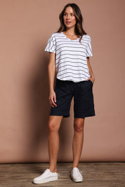 Model Madeline wearing size 10 of the Jersey Waist Linen Short in colour Navy (Blue), from the front, showing the whole outfit