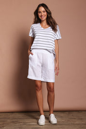 Model Madeline wearing size 10 of the Jersey Waist Linen Short in colour White (White), from the front, showing the whole outfit